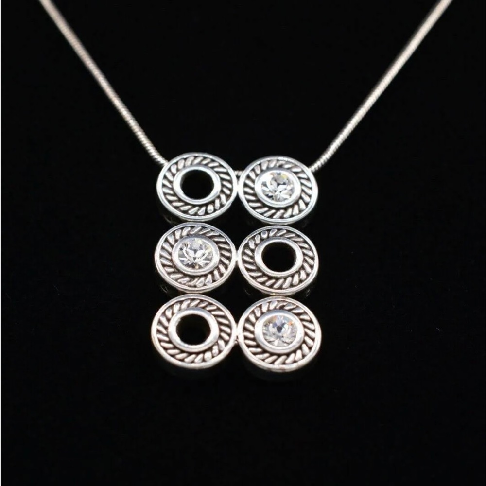 Silver with CZ.  Super cute piece!